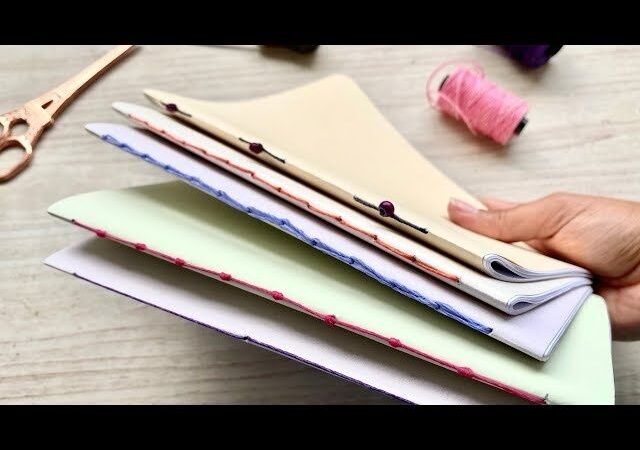 Handgebundenes Notizbuch mit sichtbaren Fadenheftungen und Papierlagen